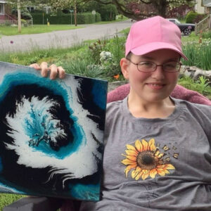 A young girl proudly displays her painting of a vibrant sunflower, showcasing her artistic talent and creativity.