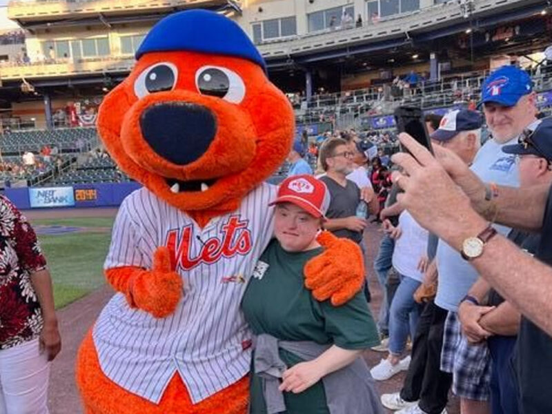 child-standing-next-sports-mascot child standing next to a sports mascot